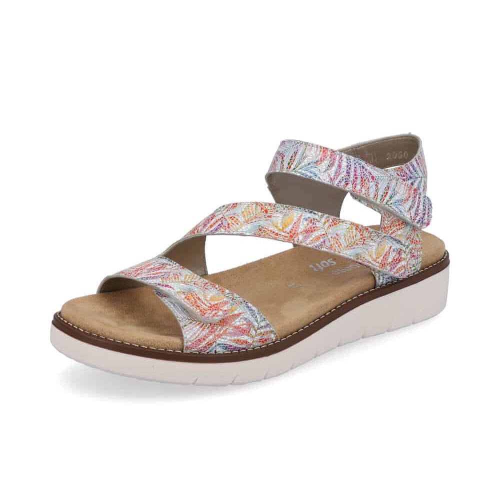 The REMONTE ASYMMETRICAL SANDAL FLORAL MULTI for women by Remonte is a comfortable, multicolored open-toe sandal featuring crisscross leather straps over the foot and around the ankle, complemented by a beige sole.