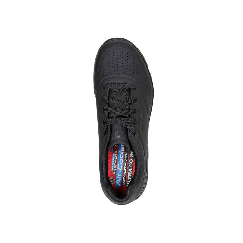 Top view of a black SKECHERS UNO SR DELONEY SAFETY TOE BLACK - WOMENS athletic shoe with perforations on the toe area, black laces, and red and white Skechers branding visible on the insole. The slip-resistant design ensures stability while the airbag midsole provides enhanced cushioning for ultimate comfort.