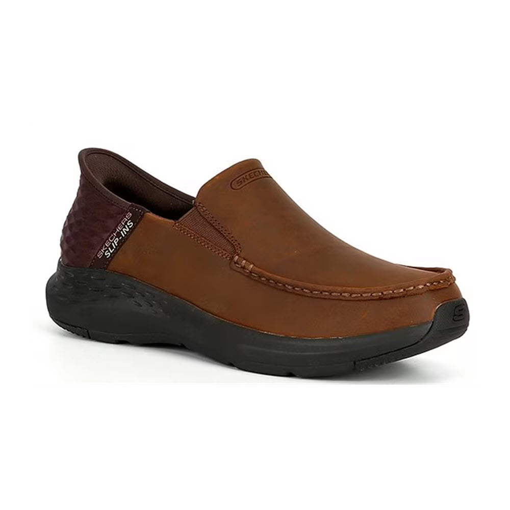 A brown leather Skechers Oswin Moc Toe slip-in shoe with a black sole, featuring Goga Mat Arch support.