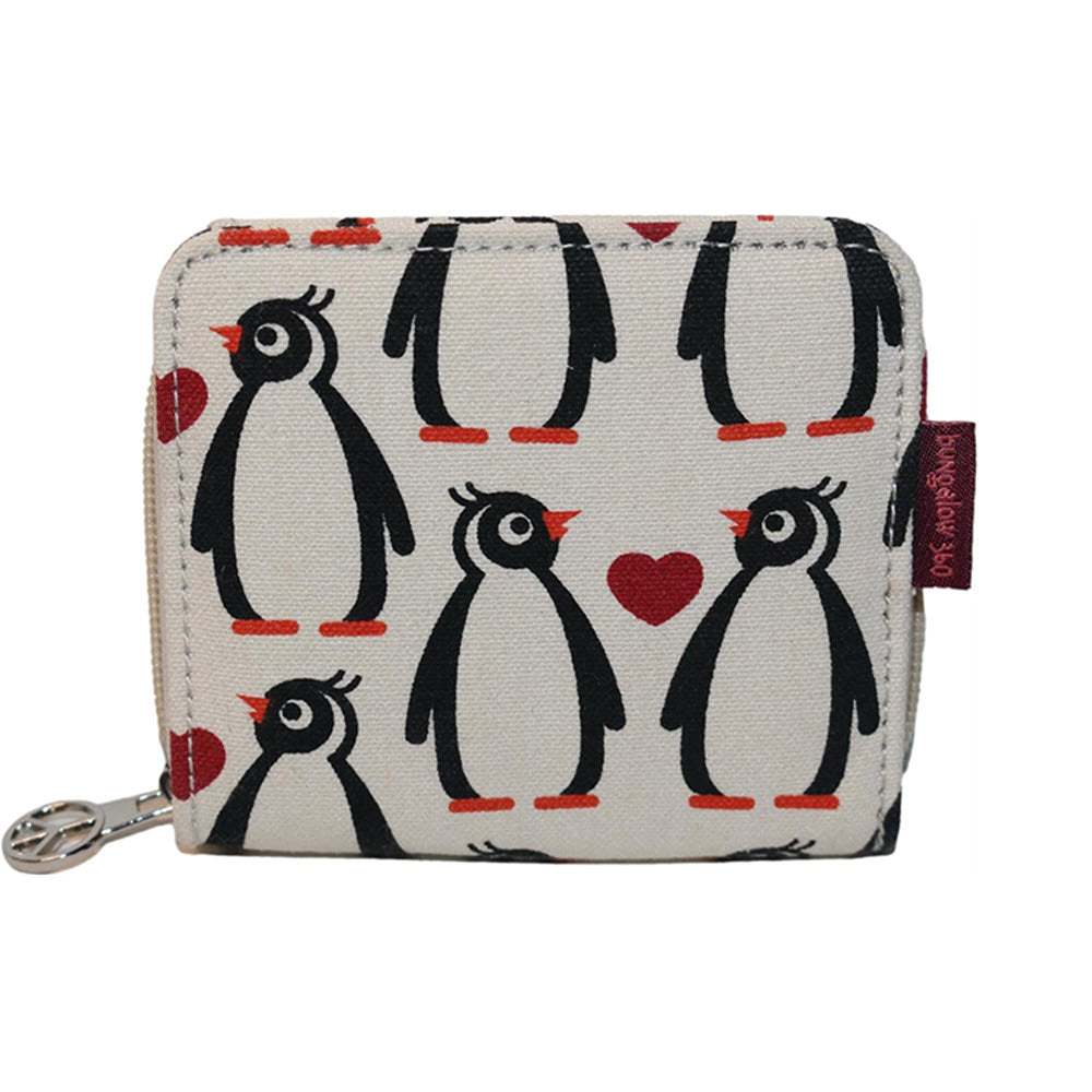 A small fabric wallet crafted from natural cotton canvas, adorned with a charming animal design featuring black and white penguins and red hearts. Designed by Bungalow 360, this BUNGALOW360 BILLFOLD WALLET PENGUIN has a zipper closure with a metallic pull tab.