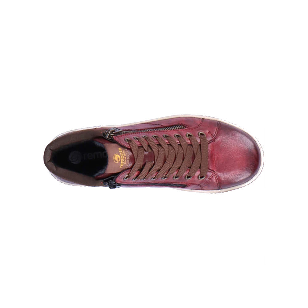 A top view of the REMONTE CITY HIGH TOP WINE - WOMENS, a red leather high-top sneaker by Remonte, featuring brown laces, dual side zippers, and a white rubber sole.