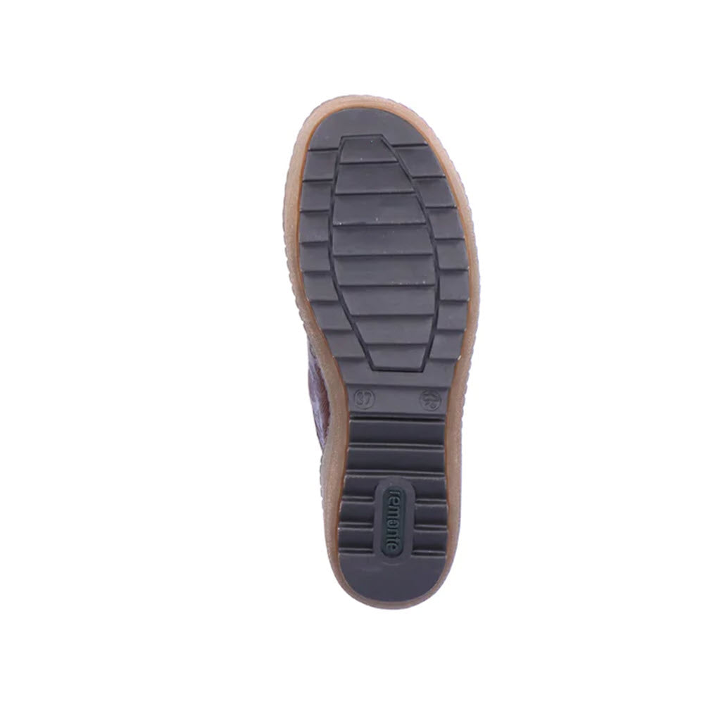 The image shows the sole of a stylish boot with a textured pattern and the brand name &quot;Remonte&quot; imprinted near the heel. The durable TR rubber outsole promises longevity while adding to its overall appeal. The sole appears to be made of sturdy rubber material, perfectly complementing the REMONTE MIXED MATERIAL HIGH TOP CHESTNUT COMBI - WOMENS.