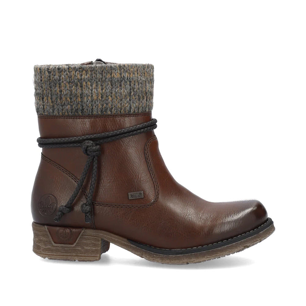 A RIEKER WOOL LINED CUFF BOOTIE WITH TIE CHOCOLATE - WOMENS by Rieker with a cozy knitted cuff, decorative lacing, faux leather upper, and low stacked heel. The sole appears textured for grip.