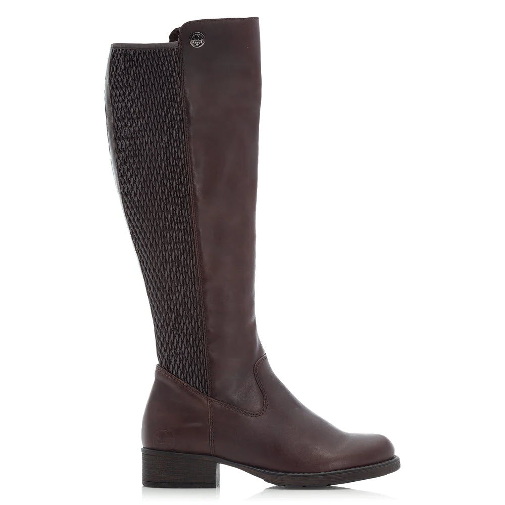 The RIEKER FAITH 91 CHOCOLATE knee-high riding boot by Rieker, featuring a dark brown finish, woven pattern on the textured back panel, and a low block heel, is shown against a white background. This stylish boot is perfect for winter footwear.