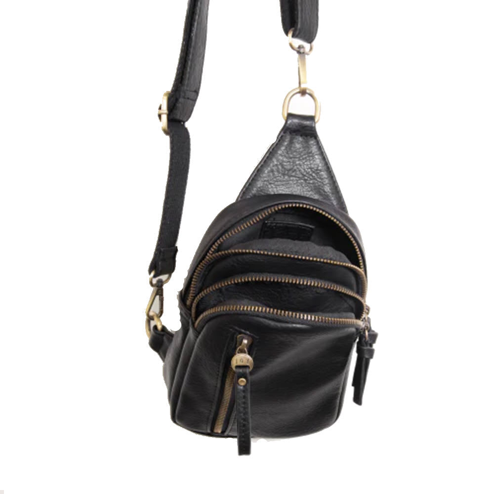 A small black vegan leather crossbody bag with multiple zippered compartments and a convertible strap, the JOY SKYLAR SLING BLACK by Joy Susan is both versatile and stylish.