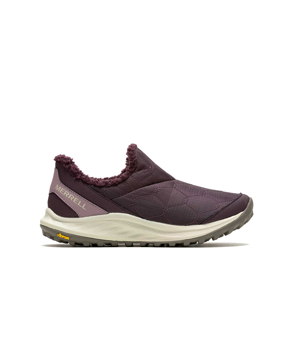 A side view of the MERRELL ANTORA 3 THERMO MOC BURGUNDY for women, a Merrell slip-on shoe featuring a quilted design in a rich burgundy color and a white sole. The heel displays a yellow Vibram logo, and it comes with a durable Vibram Ice Trek outsole, making it perfect for cold weather mocs.