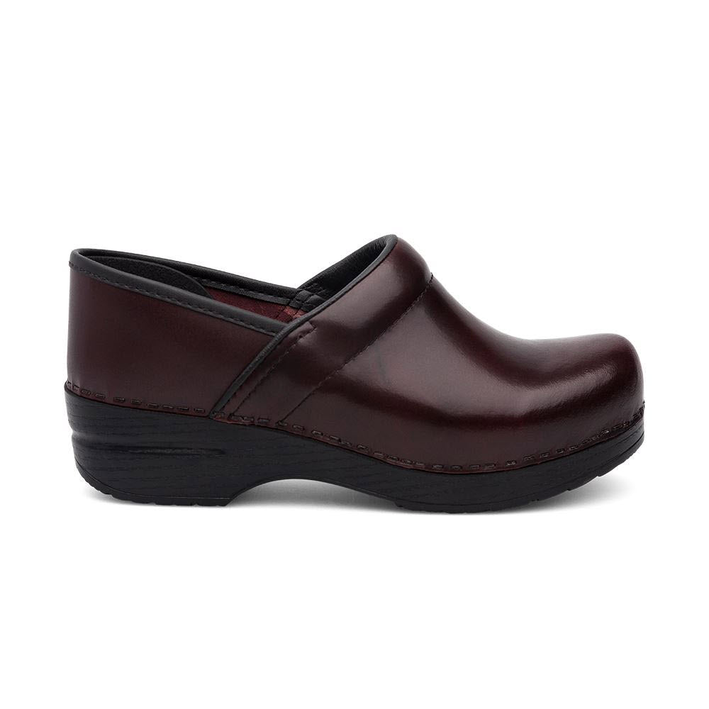 A single brown leather clog with a black cushioned sole viewed from the side, featuring an anti-fatigue rocker bottom for ultimate comfort. Introducing the DANSKO PROFESSIONAL CORDOVAN CABRIO - WOMENS by Dansko.