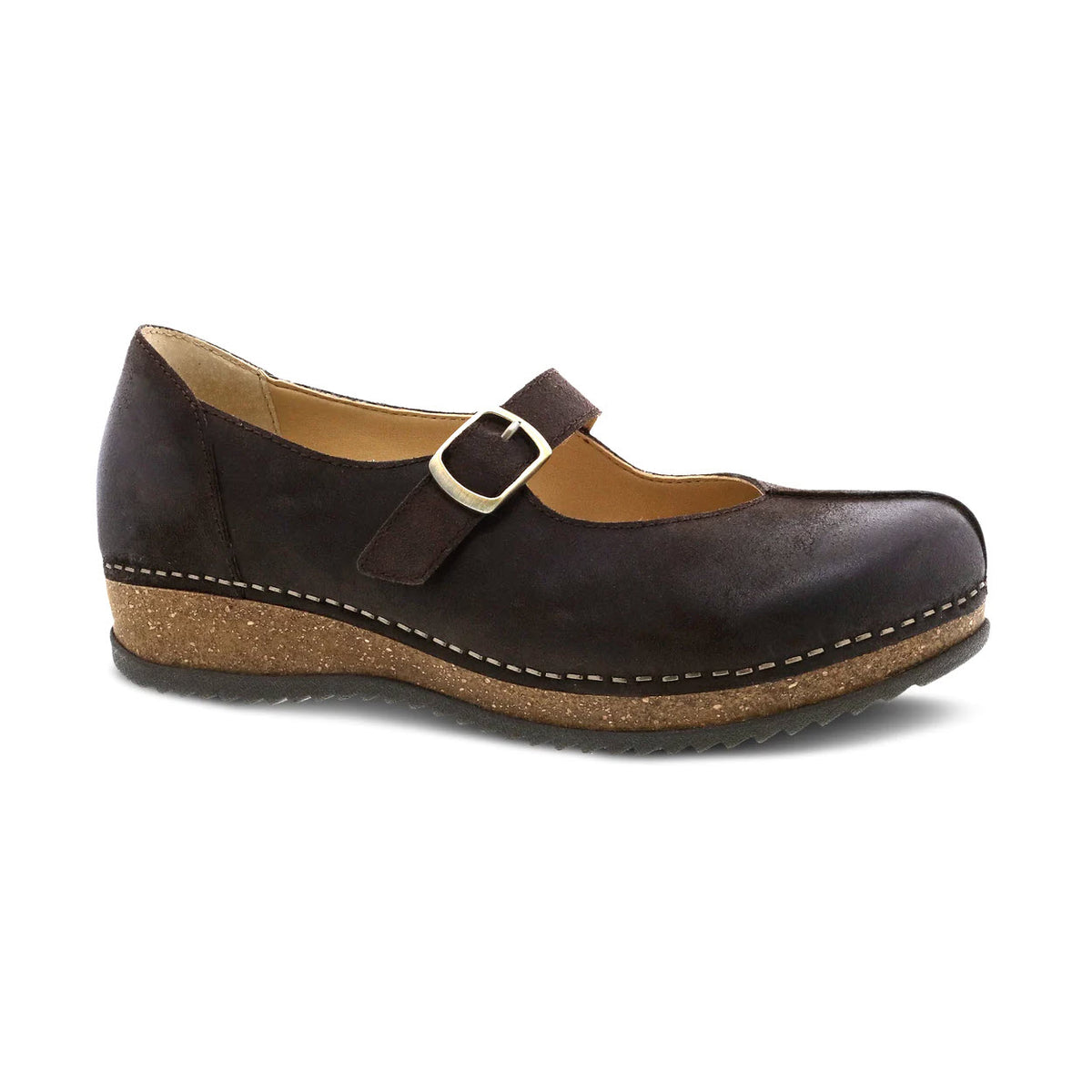 The DANSKO MIKA CHOCOLATE BURNISHED SUEDE for women features a single brown Mary Jane shoe with a strap and buckle detail, rounded toe, and a low, textured wedge sole made from a sustainable cork midsole.