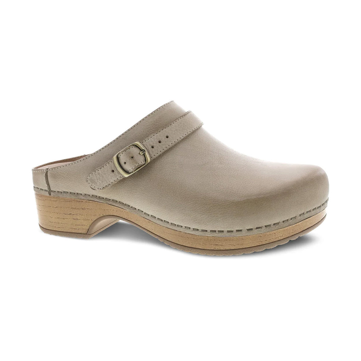 Introducing the Dansko Berry Oyster Milled for women, a versatile beige leather clog featuring a wooden sole, adjustable buckle strap, and closed toe. This stylish mule is complete with a low heel, making it perfect for any occasion.