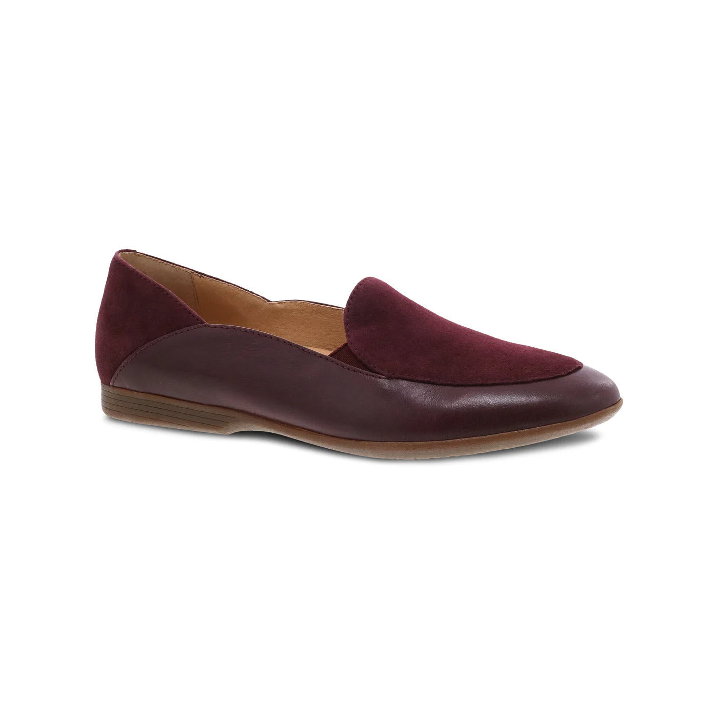 Introducing the Dansko Lace Wine Glazed for Women: A sophisticated maroon flat shoe crafted with a suede upper and a small heel, designed to provide premium arch support, as seen from the side.