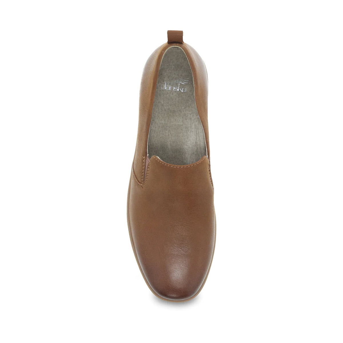 Top view of a single DANSKO LINLEY TAN BURNISHED slip-on shoe for women, showcasing a smooth, buttery soft leather finish and a pull-tab at the heel. The interior lining is gray, complementing its Dansko Natural Arch design with a molded arch shape for ultimate comfort.