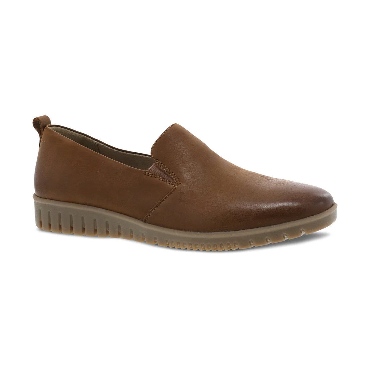 The DANSKO LINLEY TAN BURNISHED for women is a slip-on shoe from Dansko featuring a brown color and a rubber sole with a tab at the heel. Crafted from buttery soft leathers, it boasts a smooth finish and includes small elastic inserts near the tongue for a comfortable fit, along with Dansko Natural Arch support for added comfort.