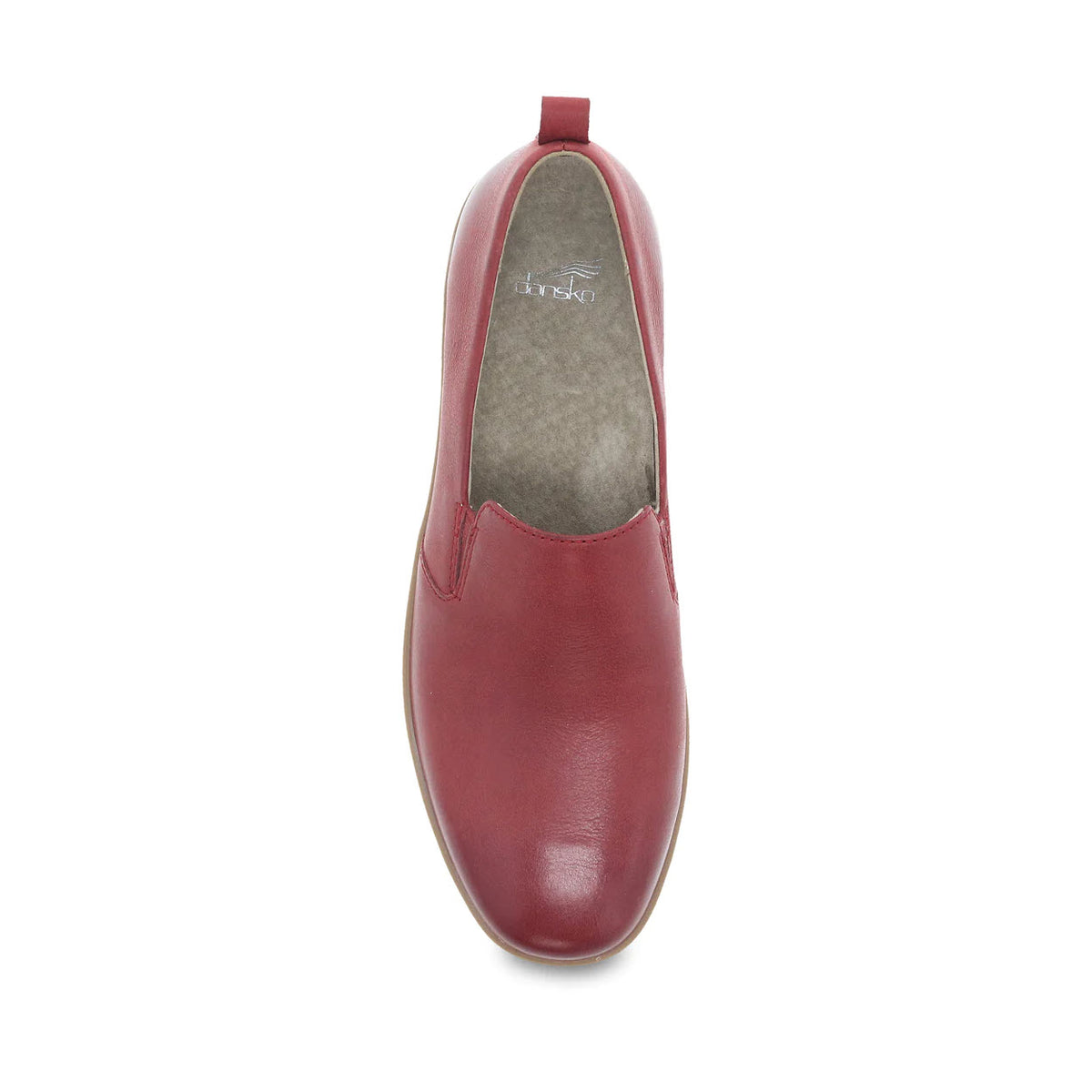 The Dansko Linley Red Burnished flat shoe for women is a slip-on featuring a rounded toe, a pull tab on the back, and buttery soft leathers with light gray interior lining.