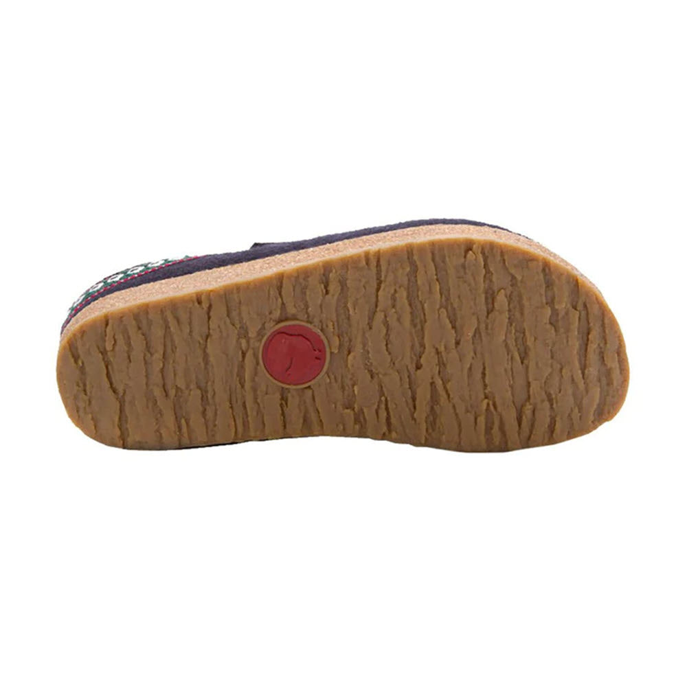 Bottom view of a Haflingers HAFLINGER GZ NAVY - WOMENS with a textured brown sole and a red circular logo in the center. The upper part of the shoe showcases a dark, patterned design on the sides, reflecting German casual style and featuring an anatomically correct footbed for comfort.