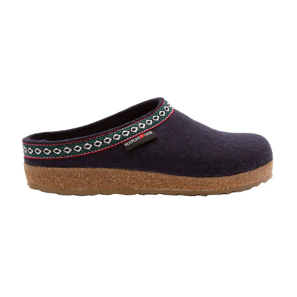 A navy blue HAFLINGER GZ NAVY - WOMENS with a cork sole, decorative trim, and an anatomically correct footbed showcasing German casual style from Haflingers.