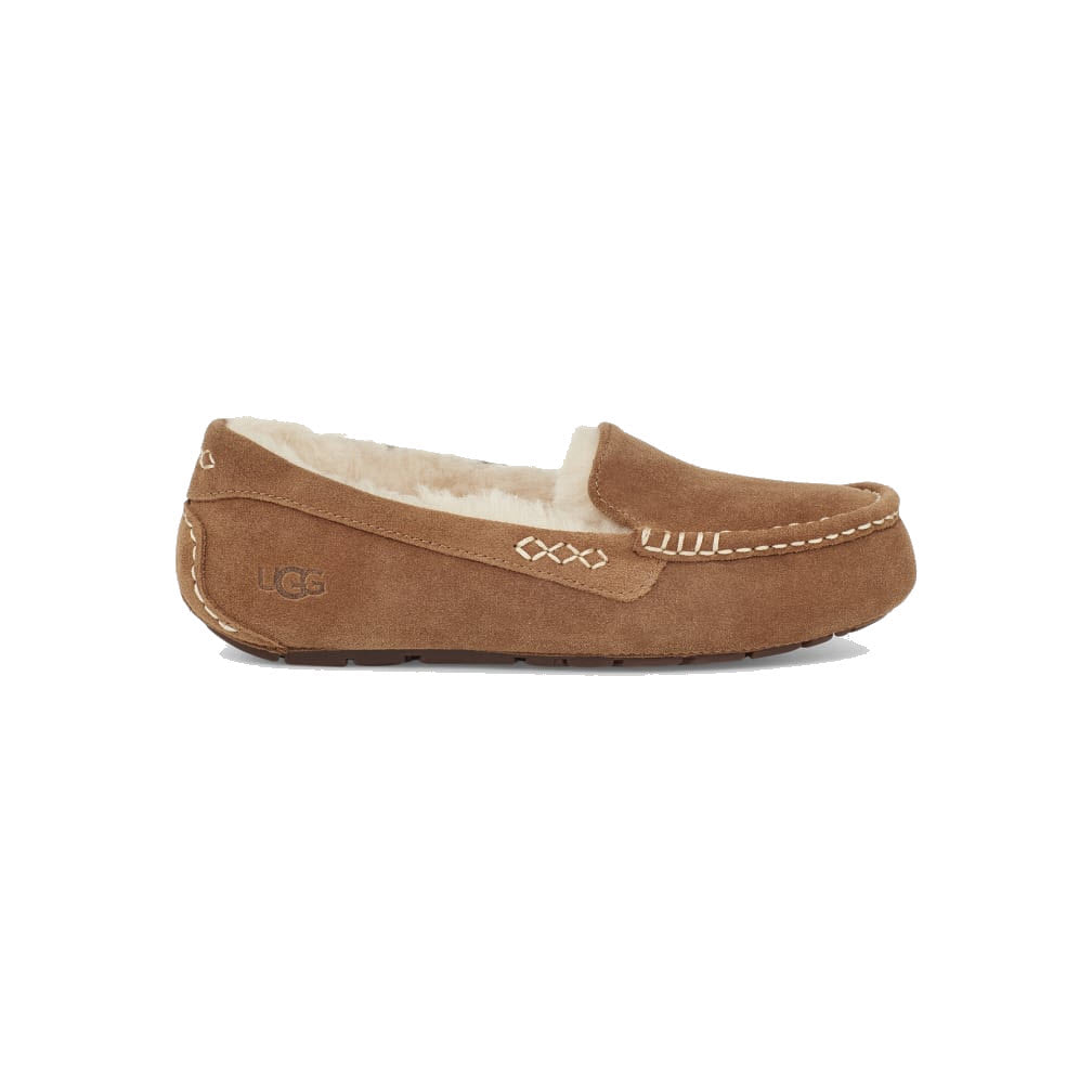 A single tan suede moccasin slipper with white stitching and a plush, wool lining interior. The Ugg logo is visible on the heel, making these UGG ANSLEY CHESTNUT - WOMENS slippers perfect for both indoor and outdoor use.