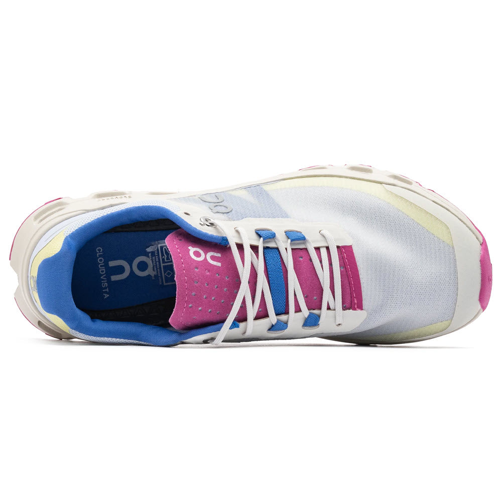 Top view of an On Running Cloudvista Heather/Rhubarb women&#39;s athletic shoe, designed for outdoor adventures in white, pink, and blue hues, featuring visible branding on the insole and tongue.