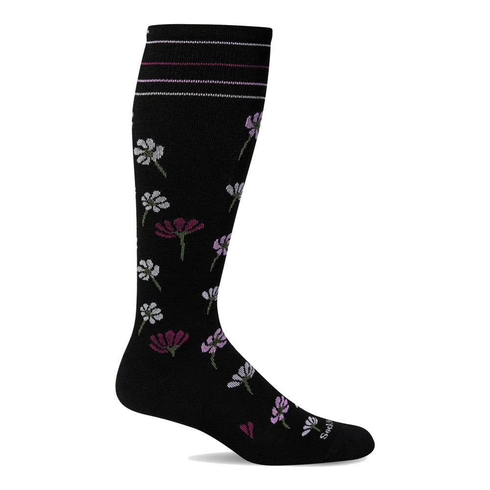 Black knee-high sock with a pattern of small white, pink, and purple flowers and two white and pink stripes near the top. Featuring an ultra light cushion sole for added comfort. Introducing the SOCKWELL COMPRESSION SOCKS FIELDFLOWERS BLACK 15-20 MMHG by Sockwell.