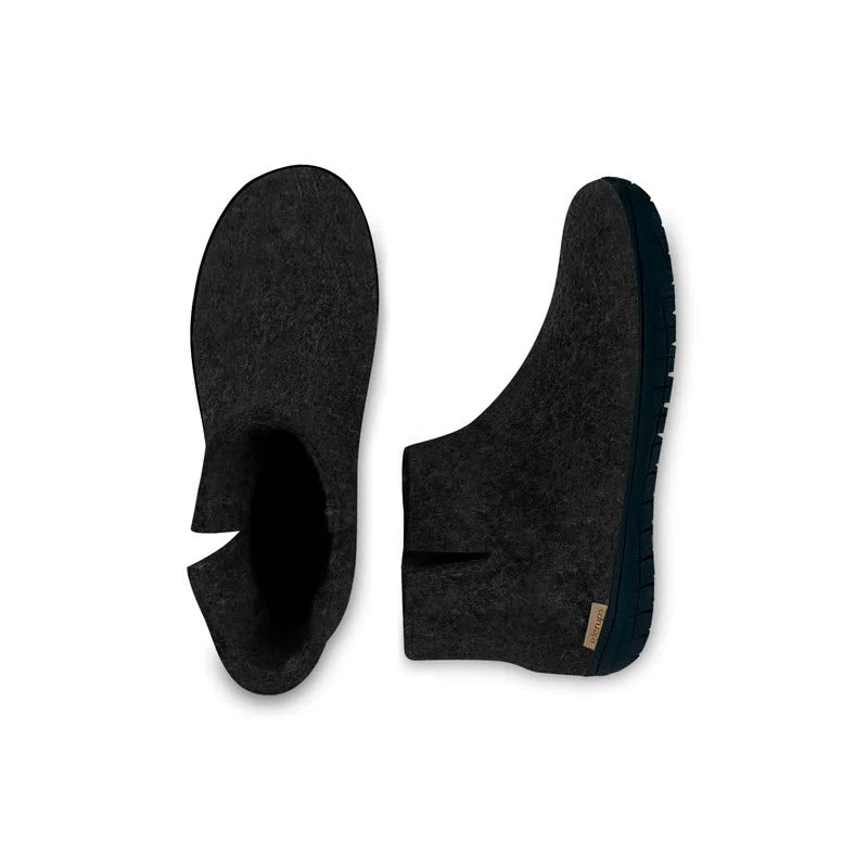 A pair of Glerups GLERUPS THE BOOT RUBBER CHARCOAL - ADULTS; the left shoe is seen from above, and the right shoe is viewed from the side, showcasing its sole and upper design. These moisture-absorbing shoes offer comfort while keeping your feet dry.