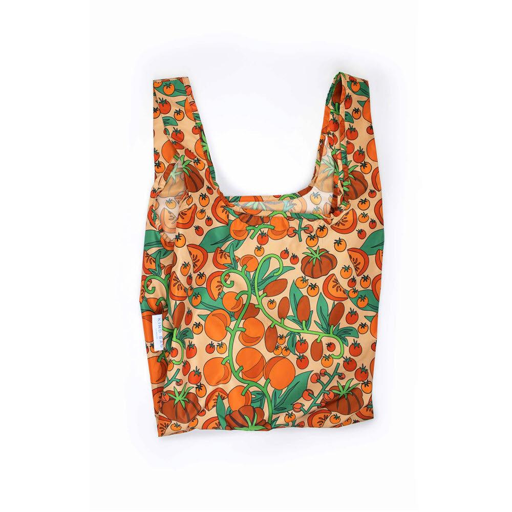 The KIND BAGS KIND MEDIUM SHOPPER BAG TOMATOES is crafted from lightweight, recycled material, featuring a colorful tomato and foliage pattern on an orange background.