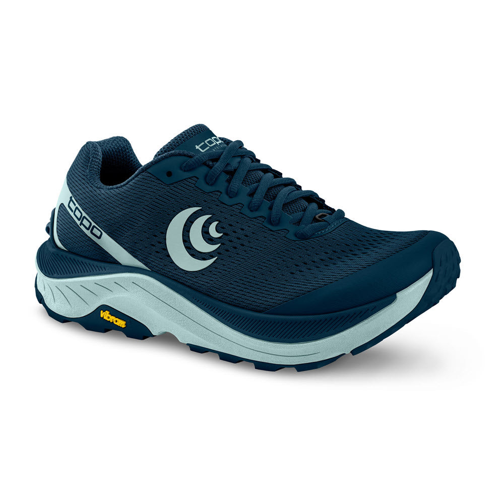 The TOPO Ultraventure 3 Navy/Blue Women&#39;s sneaker features &quot;TOPO&quot; branding on a mesh upper, a thick cushioned platform sole, and a Vibram® XS Trek EVO logo on the side.