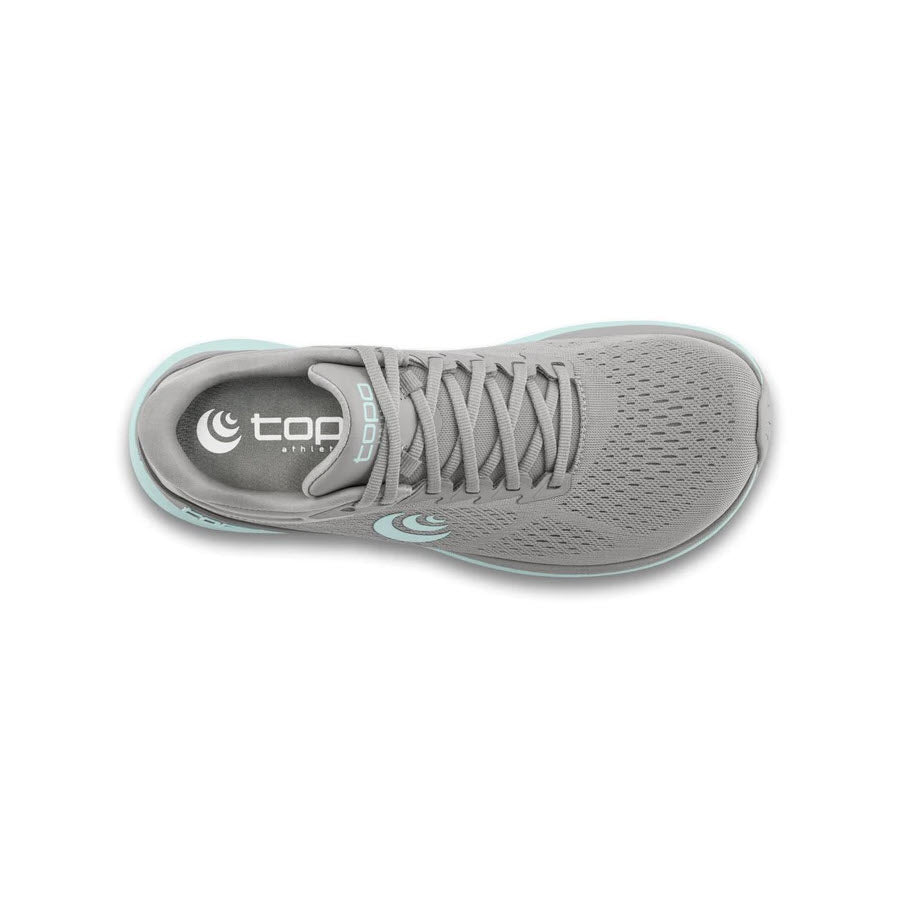 Top view of a single TOPO Phantom 3 Grey/Stone running shoe by Topo Designs for women, featuring a blue sole and laces, with the &quot;topo&quot; logo visible on the insole. Designed for cushioning, this daily trainer effortlessly combines comfort and style.