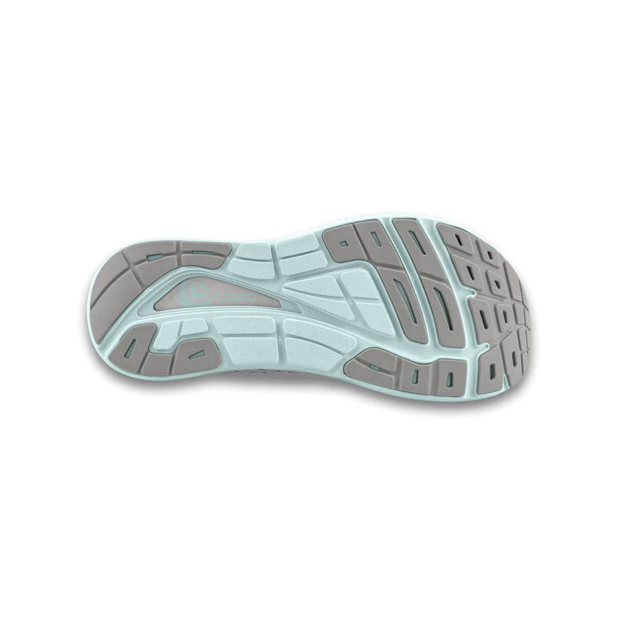 The image shows the sole of a grey and stone-colored Topo Designs TOPO PHANTOM 3 for women, featuring a pattern of grooves and flex lines for traction and flexibility, making it an ideal daily trainer with excellent cushioning.