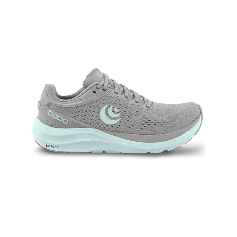 A side view of the TOPO PHANTOM 3 GREY/STONE - WOMENS by Topo Designs showcases light blue accents and the Topo logo on the side. This daily trainer features a breathable mesh upper and a cushioned ZipFoam sole, providing exceptional cushioning for your runs.