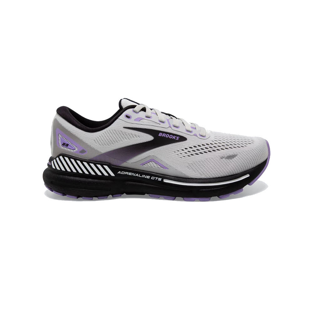 Side view of the Brooks Adrenaline GTS 23 women's running shoe in grey, black, and purple, featuring a lace-up closure, breathable mesh upper, and cushioned sole for ultimate support and softness.