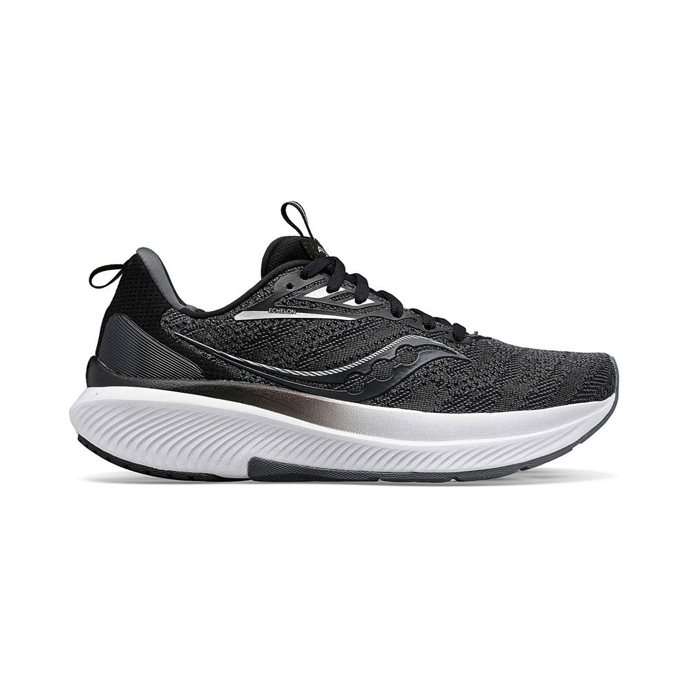 A black and gray athletic shoe with a white, thick sole, designed for running, shown from the side. The Saucony SAUCONY ECHELON 9 BLACK/WHITE - MENS features max cushioning and is orthotics-friendly.