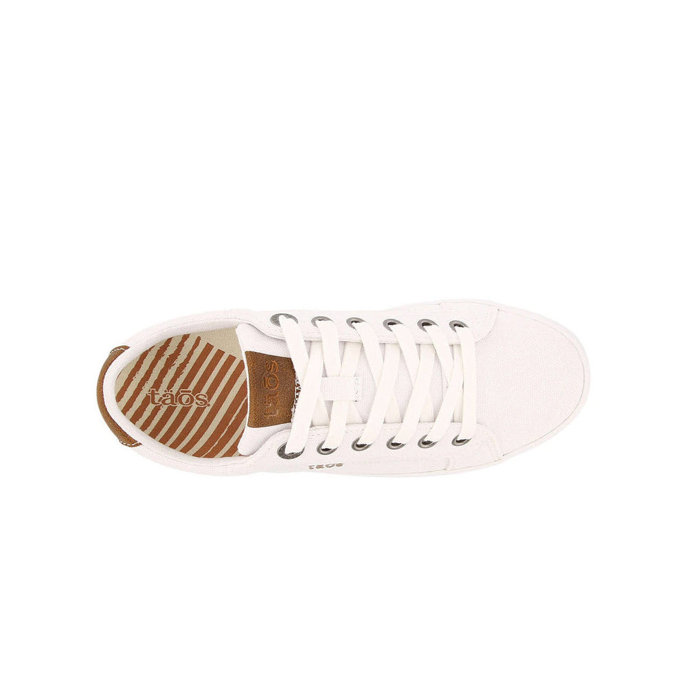 Top view of a single TAOS STAR BURST WHITE women&#39;s sneaker with laces. The insole has a striped pattern, while the heel area proudly displays the Taos brand name. This design also features a custom fit and fabricated leather trim for added style and comfort.