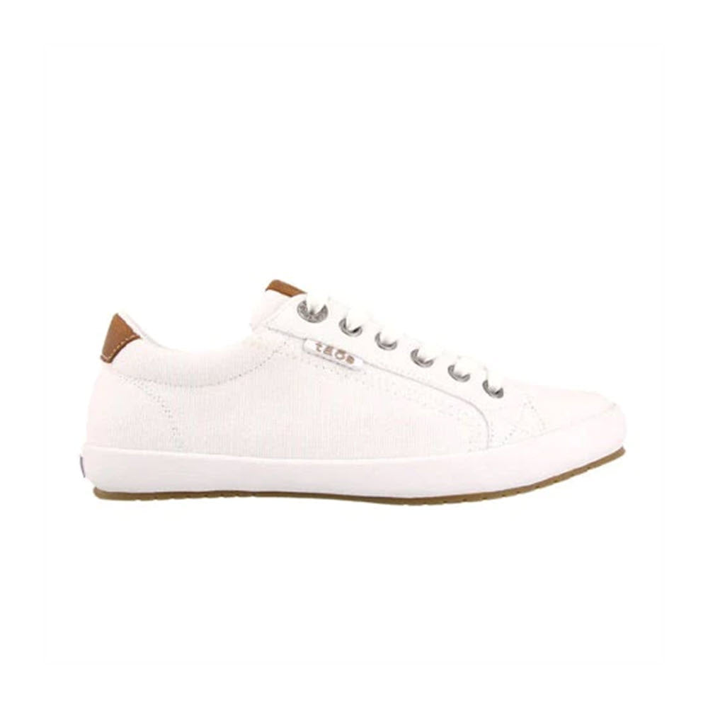 Side view of the TAOS STAR BURST WHITE - WOMENS casual sneaker by Taos, featuring a rubber sole, metal eyelets, and fabricated leather trim with a brown accent on the heel.