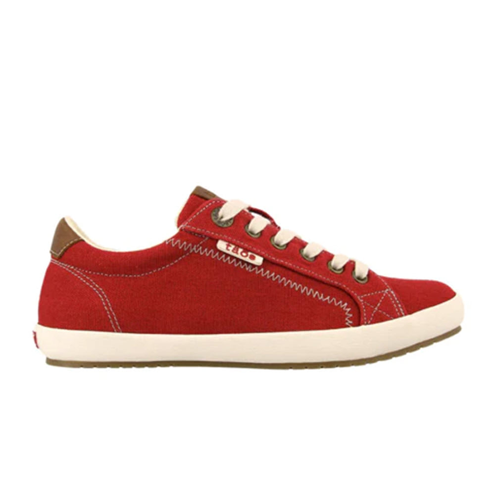 The TAOS STAR BURST RED - WOMENS by Taos is a single red canvas sneaker featuring white stitching, beige laces, and a white rubber sole with fabricated leather trim, as seen from the side.