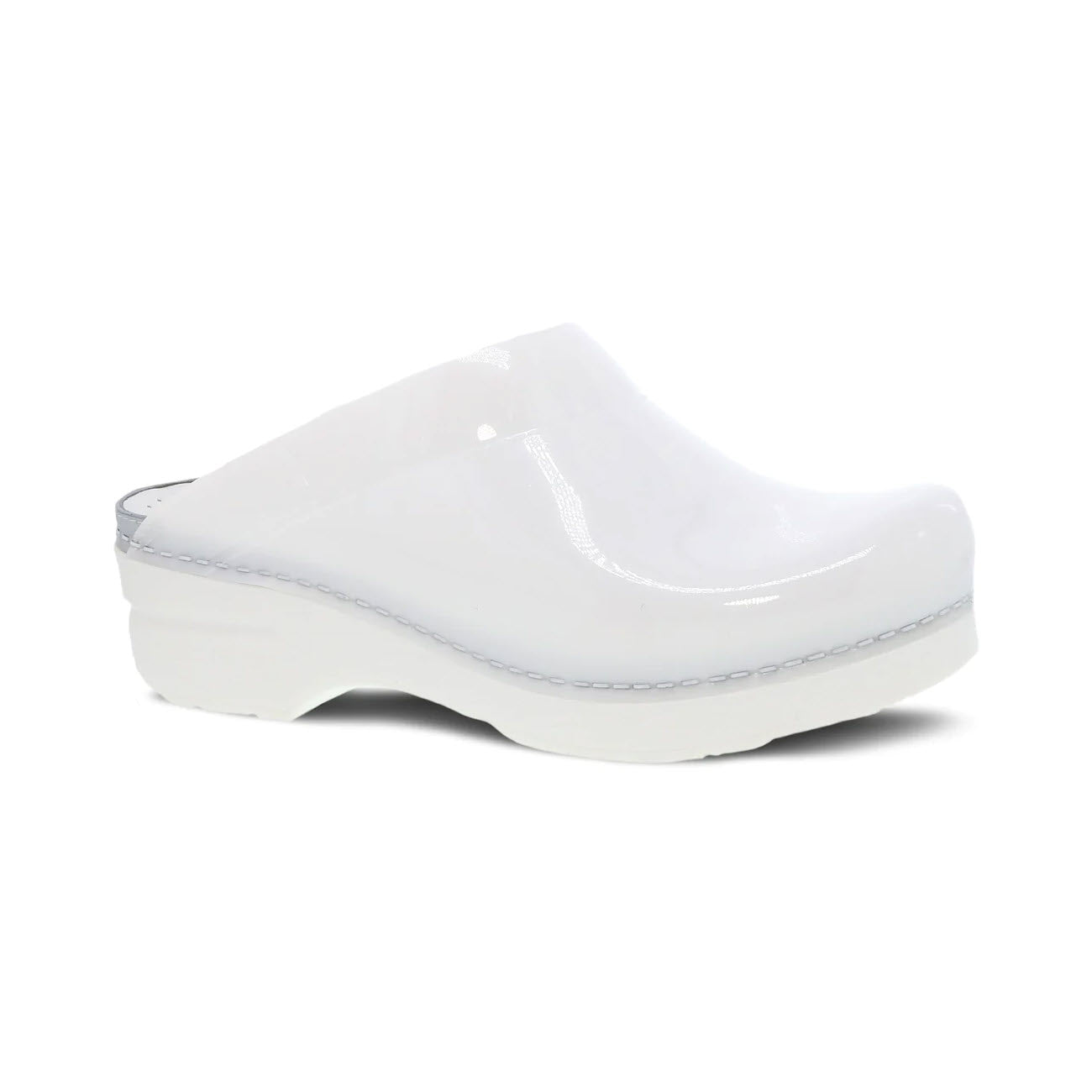 The DANSKO SONJA WHITE TRANSLUCENT for women by Dansko is a white leather clog shoe featuring a wedge heel, open back style, and visible stitching on the sole, all of which provide legendary comfort.