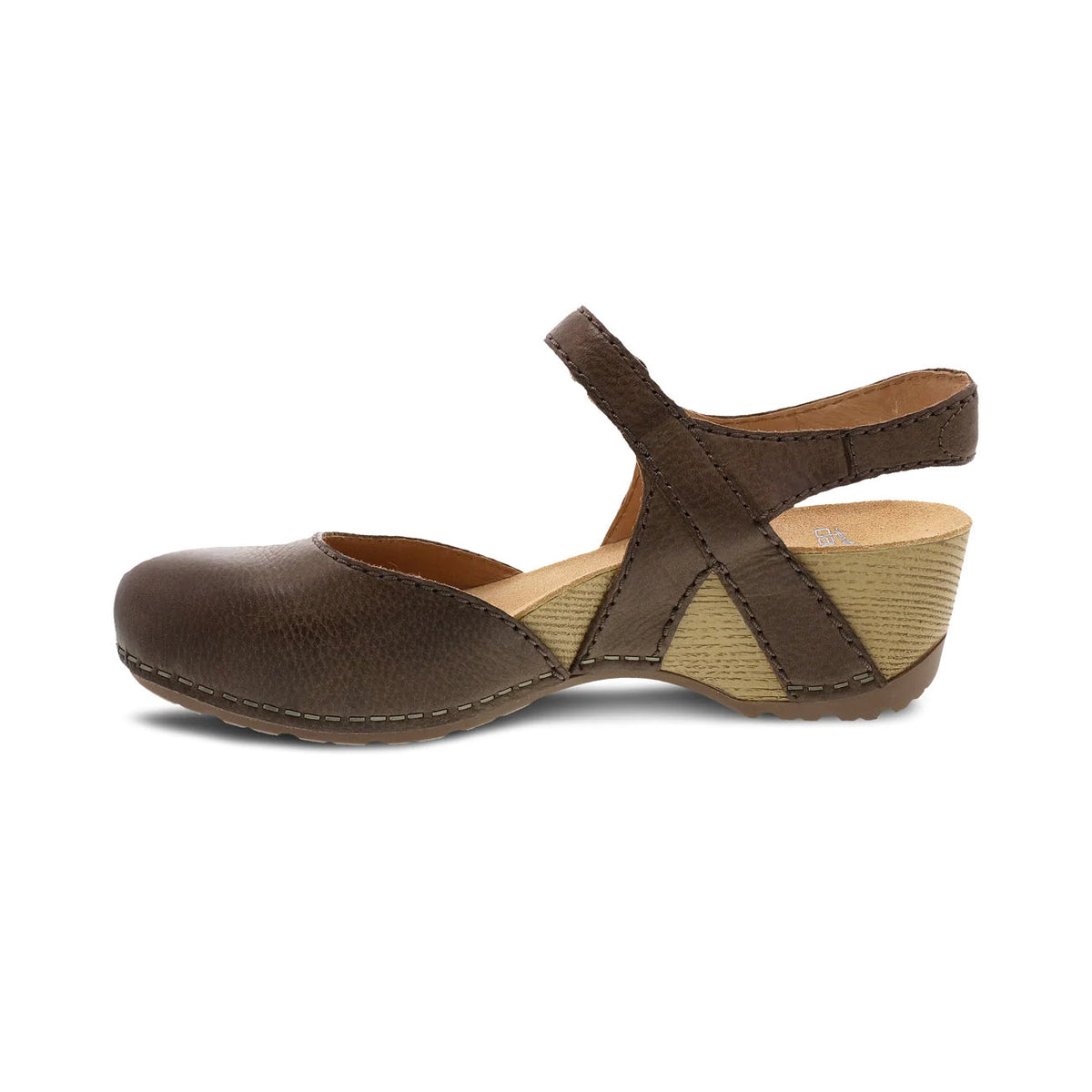 Side view of a DANSKO TIFFANI BROWN - WOMENS closed toe sandal with a textured wedge heel, featuring an adjustable strap wrapping over the instep and around the ankle. Perfect for spring fashion.