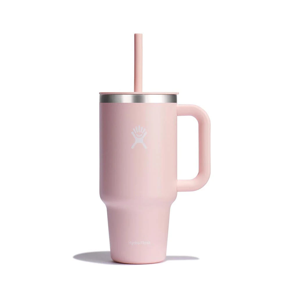 A pink HYDRO FLASK 32OZ TRAVEL TUMBLER TRILLIUM by Hydro Flask with TempShield insulation, featuring a handle, lid, and flexible straw.