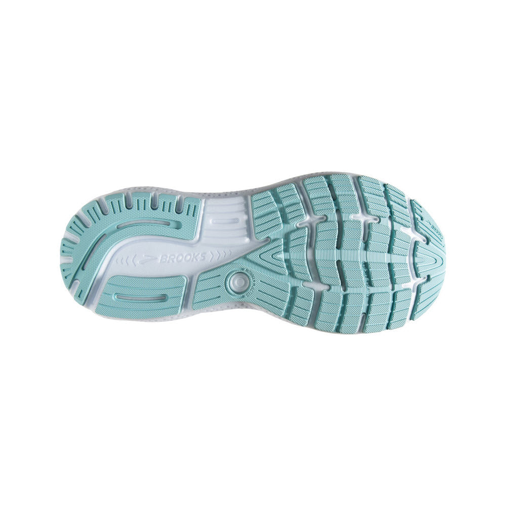 The sole of the Brooks Ghost 16 White/Grey/Estate Blue women&#39;s shoe, a well-cushioned daily trainer, features a turquoise tread pattern with white detailing. The design includes multiple grooves for traction.