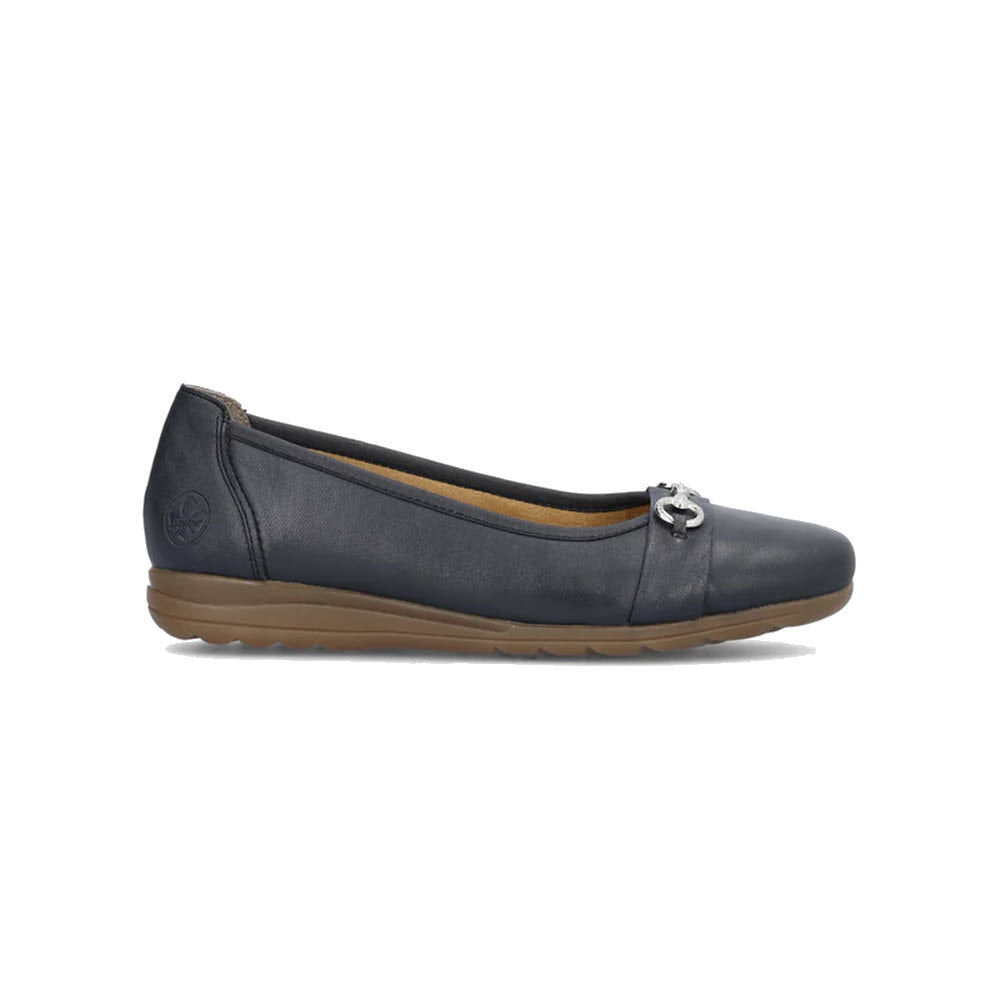 A single RIEKER BALLET FLAT NAVY - WOMENS by Rieker, featuring a dark blue leather exterior with a silver decorative buckle on the front and a brown textured sole, seen from the side.