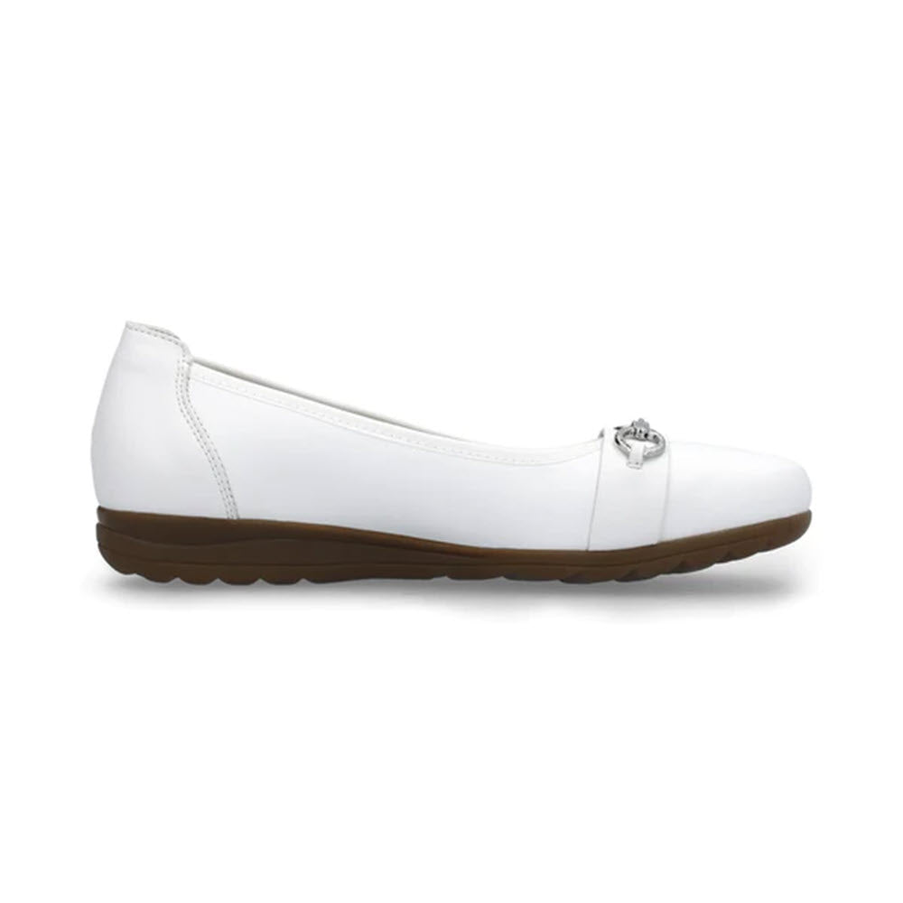 The RIEKER BALLET FLAT WHITE - WOMENS is a classic slip-on crafted from high-quality leather, featuring a white flat design with a brown sole and a small silver buckle detail on the front.