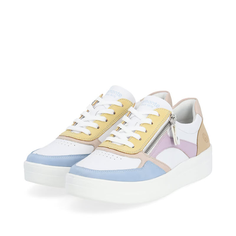 The REMONTE EURO COURT SNEAKER PASTEL MULTI - WOMENS by Remonte is a pair of stylish sneakers that blends white with pastel hues including yellow, blue, and purple. It features smooth leather accents, white laces, and side zipper details. Enjoy unparalleled comfort with Lite &#39;n Soft technology for all-day wear.