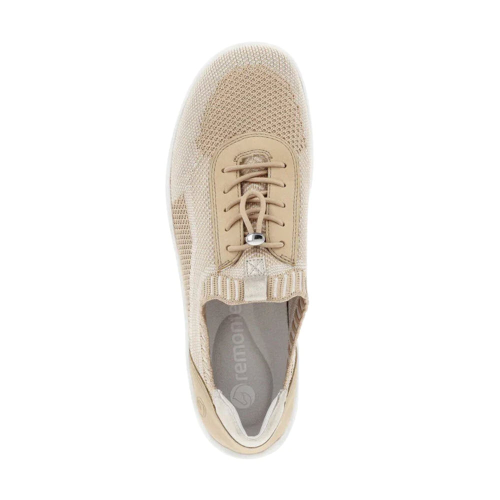 Top view of a beige REMONTE LITE &amp; SOFT SNEAKER VANILLA - WOMENS with a knit upper, white sole, and a Remonte logo on the insole. The shoe features a toggle lace closure and an elastic band for added comfort.