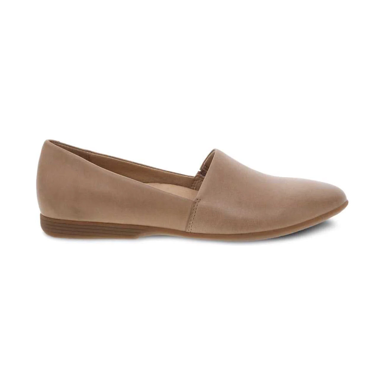 A beige, slip-on flat shoe by Dansko featuring a slightly pointed toe, low stacked heel, and superior arch support is the Dansko Larisa Taupe - Women's.