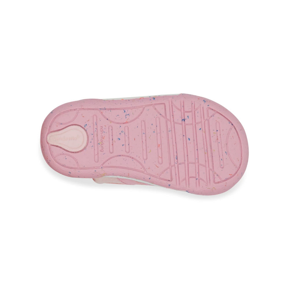 The bottom of a single pink STRIDE RITE SR FERN PINK - KIDS sneaker with a patterned sole and speckled accents is shown.