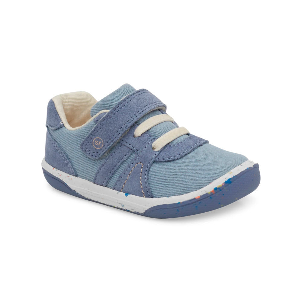 A single light blue toddler STRIDE RITE SR FERN BLUE - KIDS Sneaker with white laces, a blue velcro strap, and a white and blue speckled sole, crafted with organic cotton by Stride Rite, is displayed against a white background.