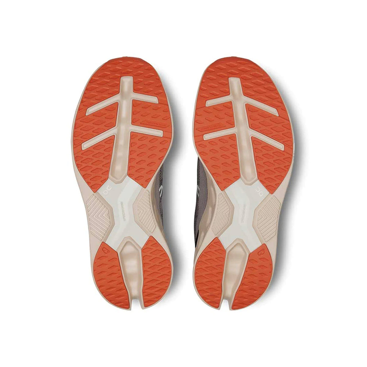 The image showcases the soles of the ON CLOUDECLIPSE FADE/SAND - WOMENS athletic shoes by On Running, featuring an orange and beige tread pattern designed for grip and traction, enhanced by CloudTec sole technology.