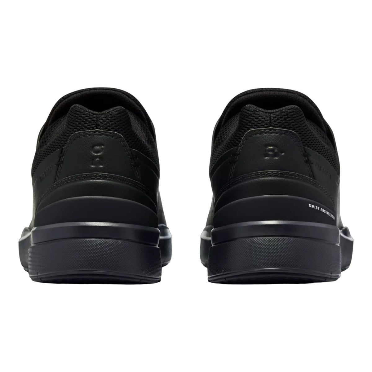 Rear view of THE RODGER ADVANTAGE ALL BLACK - WOMENS by On Running, a pair of black athletic shoes with textured soles, CloudTec® cushioning, and sleek, minimalist design.