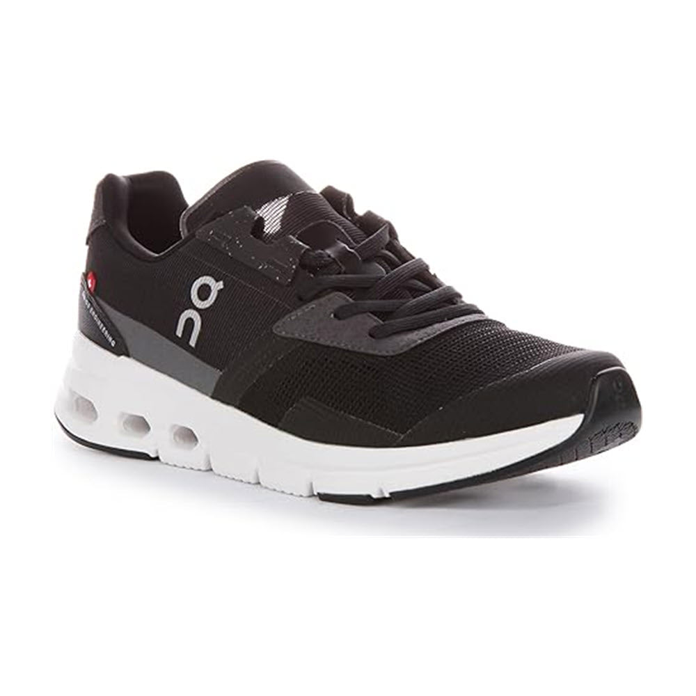 The ON CLOUDRIFT BLACK/WHITE - WOMENS is an athletic shoe from On Running, featuring the brand&#39;s logo on the side and a uniquely designed sole with breathable mesh for optimal comfort.