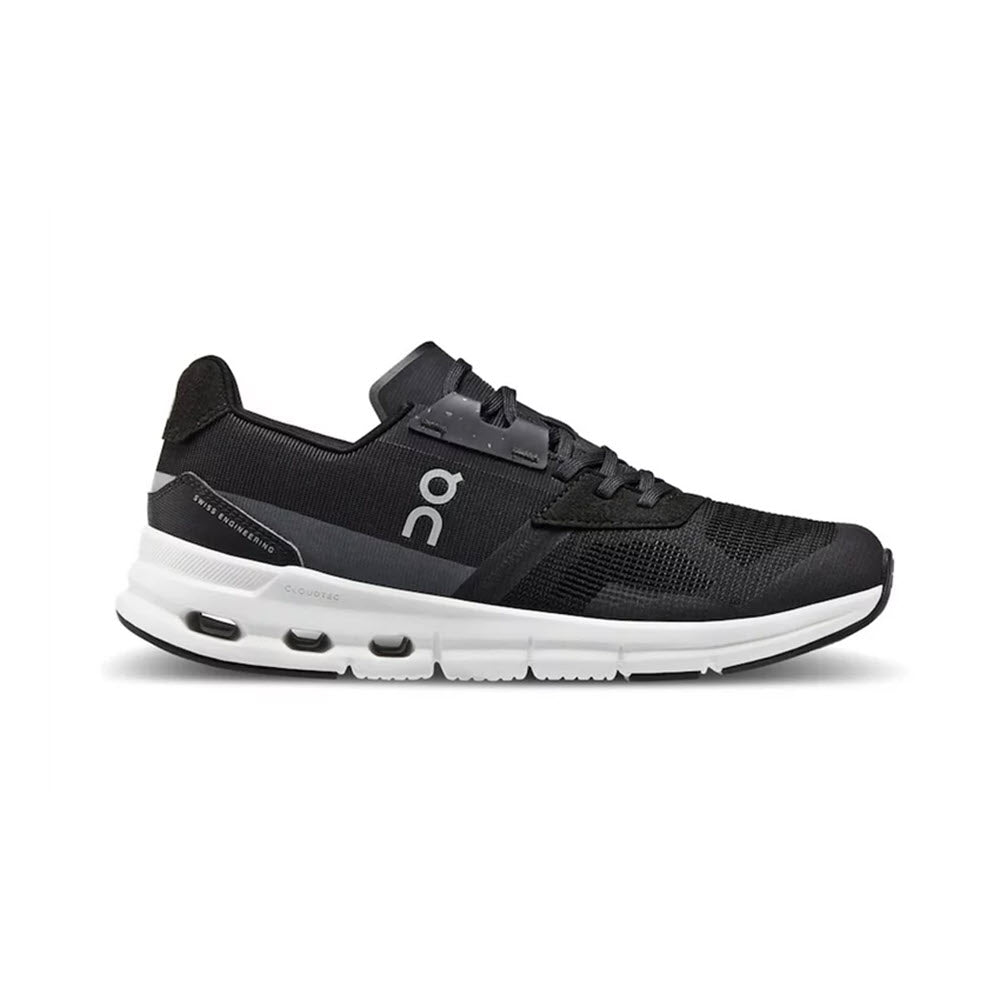 The ON Cloudrift Black/White women&#39;s athletic shoe from On Running boasts breathable mesh fabric and a cushioning sole. It features a lace-up design and a logo on the side, offering both style and comfort.