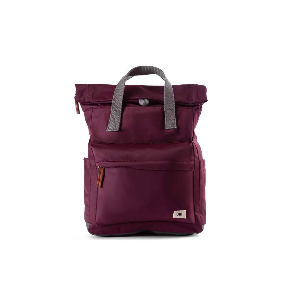 A maroon backpack with grey shoulder straps, a small front pocket, and an ORI LONDON CANFIELD B MD B NYLON PLUM design, making it the perfect travel accessory from Ori London.