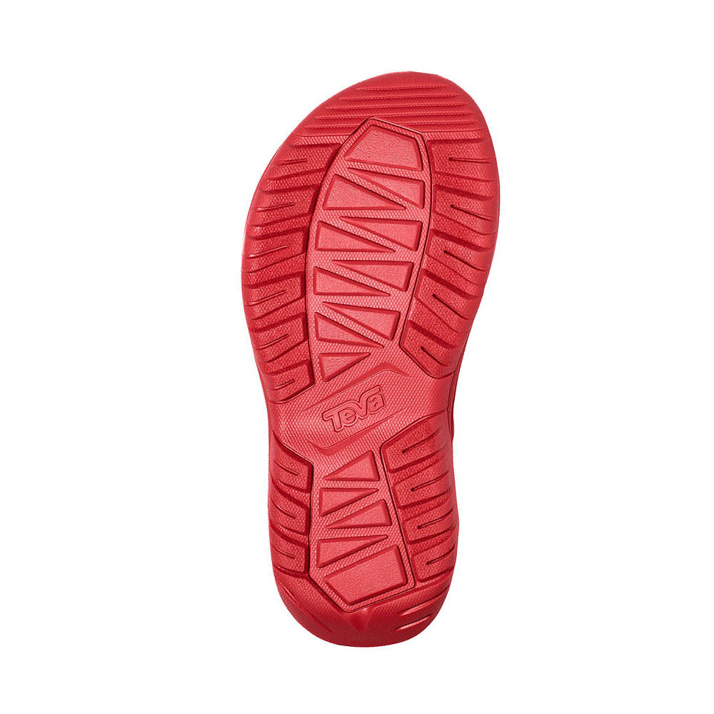 Red rubber shoe sole featuring textured patterns and the brand name &quot;Teva&quot; embossed in the center, designed for the TEVA HURRICANE XLT2 TOMATO PUREE - WOMEN with straps made from REPREVE polyester webbing, utilizing recycled plastic bottles.